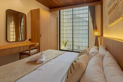 a bedroom with a large bed with a large window at Vin Villa Kerobokan 2BR with Private Pool in Kerobokan