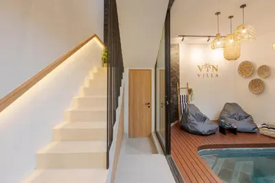 a house with a staircase and a swimming pool at Vin Villa Kerobokan 2BR with Private Pool in Kerobokan