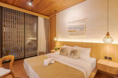 a hotel room with a bed and a balcony at Vin Villa Kerobokan 2BR with Private Pool in Kerobokan