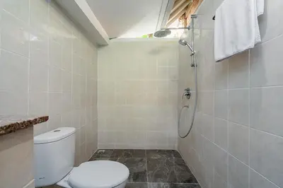 a bathroom with a toilet and a shower at Green Garden Seminyak Villa in Seminyak