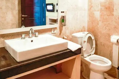 a bathroom with a sink and a toilet at First Home Stay in Ngurah Rai International Airport