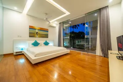 a bedroom with a bed and a large window at Villa Aquila in Seminyak