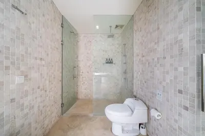 a bathroom with a toilet and a shower at Villa Aquila in Seminyak