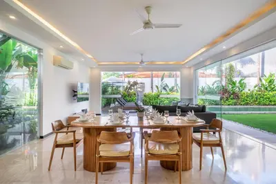 a dining room with a table and chairs at Villa Aquila in Seminyak