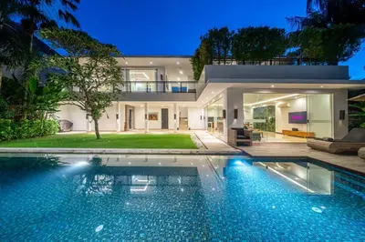 a house with a swimming pool in front of it at Villa Aquila in Seminyak