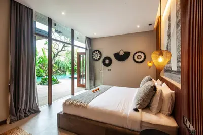 a bedroom with a large bed and a large window at Luxury 6BR villa Berawa beach in Canggu