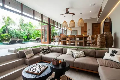 a living room with a couch and a table at Luxury 6BR villa Berawa beach in Canggu