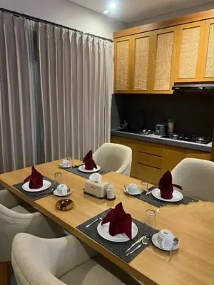 a wooden table with red hats on top of it at Villa in South Kuta Dewi Amerta villa in Jimbaran