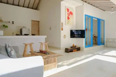 a living room with a couch and a tv at Beji Ayu Seminyak - 1 Bedroom Private Villa in Seminyak