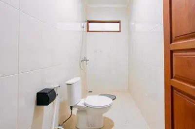 a white bathroom with a toilet and a phone at Nice Villa In Seminyak #YoNa in Seminyak