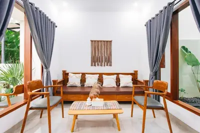 a living room with a couch and two chairs at Nice Villa In Seminyak #YoNa in Seminyak