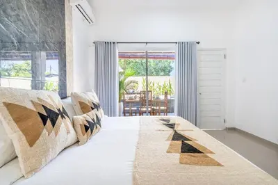 a bedroom with a large white bed with pillows at RK3, 2 beds villa 15 min walk to Double Six Beach in Seminyak