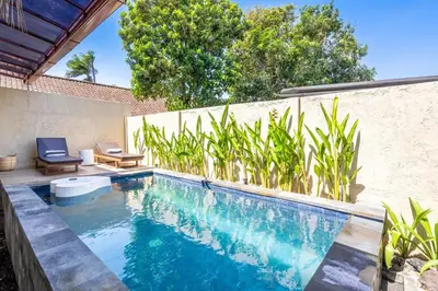 a swimming pool in a backyard with a fence at RK3, 2 beds villa 15 min walk to Double Six Beach in Seminyak