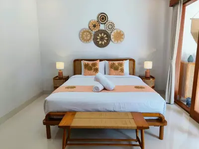 a bedroom with a large bed with two pillows at RK4 Brand New 2Bedroom Villa Near Seminyak in Seminyak
