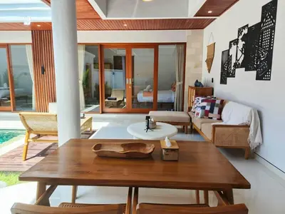 a living room with a wooden table and a couch at RK4 Brand New 2Bedroom Villa Near Seminyak in Seminyak