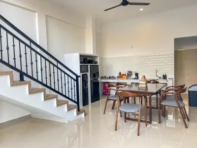 a kitchen and dining room with a table and chairs at RK5, 2 beds villa 15 min walk to Double Six Beach in Seminyak