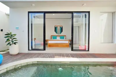 a room with a pool and a bed and a bedroom at Bright, Airy & Private, your 2BR Bali Escape in Seminyak