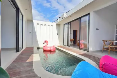 a swimming pool with a pink swan in a house at Bright, Airy & Private, your 2BR Bali Escape in Seminyak