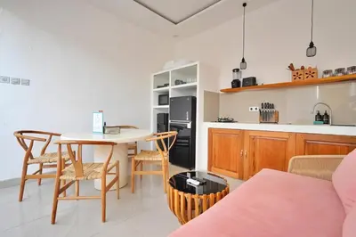 a kitchen and dining room with a table and chairs at Bright, Airy & Private, your 2BR Bali Escape in Seminyak