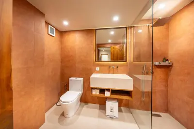 a bathroom with a toilet and a sink and a shower at Gate 11 Mezzanine one in Denpasar