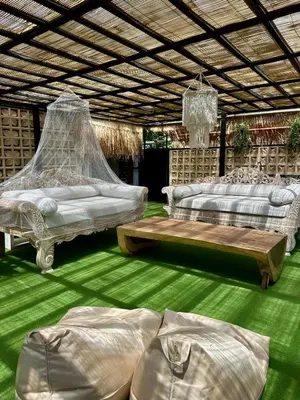 a living room with two beds and a table at Villa Vela 2 BR - Vela 3 with Private Pool & Rooftop in Seminyak