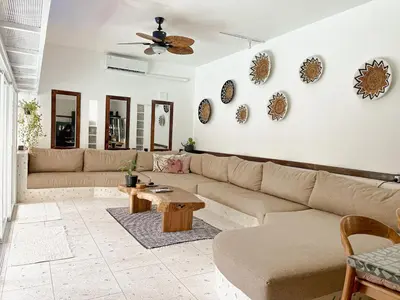 a living room with a couch and a table at Villa Vela 2 BR - Vela 3 with Private Pool & Rooftop in Seminyak