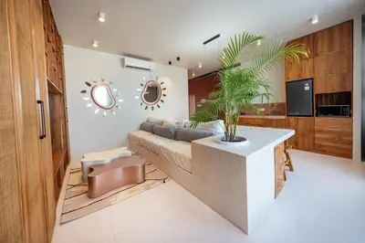 a living room with a couch and a potted plant at Gate 11 Spacious Apartment 1 Stylish 3rd Floor in Seminyak