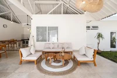 a living room with a table and chairs at Uma dharma villas 2 in Seminyak