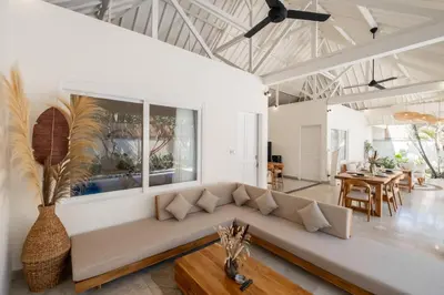 a living room with a couch and a table at Uma dharma villas 2 in Seminyak