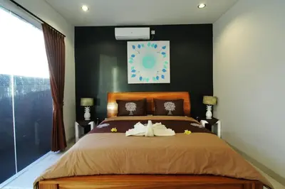 a bedroom with a bed with two towels on it at Villa Dreamz - six bedrooms private villa in Legian