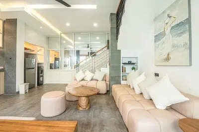 a living room with a couch and a table at Splendid Villa 3Br Center Seminyak in Seminyak