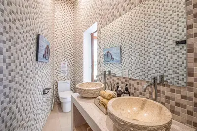 a bathroom with a large sink and a toilet at Splendid Villa 3Br Center Seminyak in Seminyak