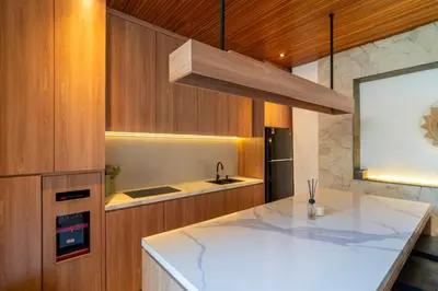 a kitchen with a white counter top and a sink at Modern 3BR Villa Seminyak, central location in Seminyak