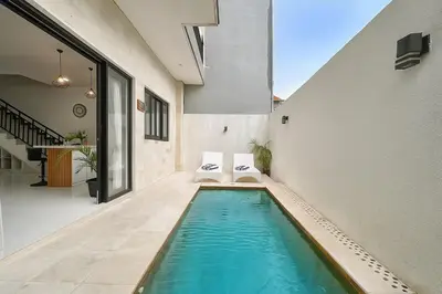 a swimming pool in the middle of a house at Villa Lisa - 3BR with pool Near Bali Mall Galleria in Kuta