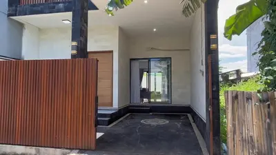 an open door of a house with a wooden fence at Villa Lisa - 3BR with pool Near Bali Mall Galleria in Kuta