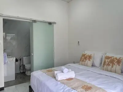 a bedroom with a bed with two towels on it at Villa Lisa - 3BR with pool Near Bali Mall Galleria in Kuta