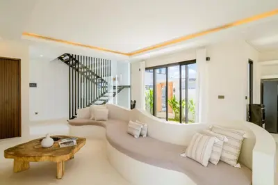 a living room with a couch and a table at Sunset room in a shared 4 bedroom villa in Canggu