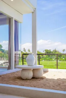 a vase sitting on a table in a room with a window at Sunset room in a shared 4 bedroom villa in Canggu