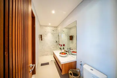 a bathroom with a sink and a shower at Villa Lavender Seminyak in Seminyak