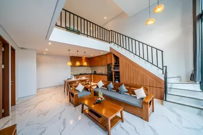 a living room with a couch and a table at Villa Lavender Seminyak in Seminyak