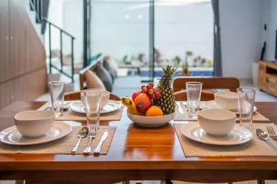 a wooden table with a bowl of fruit on it at Villa Lavender Seminyak in Seminyak