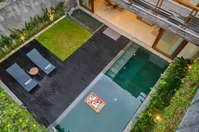 an overhead view of a swimming pool with a table and chairs at Annora Cozy 3 BR Private Pool Villa in Canggu