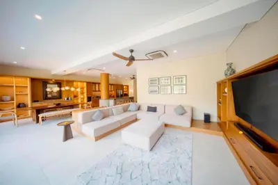 a living room with a couch and a flat screen tv at Annora Cozy 3 BR Private Pool Villa in Canggu