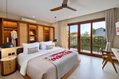 a bedroom with a large bed and a balcony at Annora Cozy 3 BR Private Pool Villa in Canggu