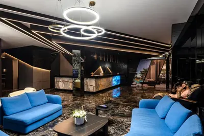 a living room with blue couches and a fireplace at The Umalas Signature in Canggu