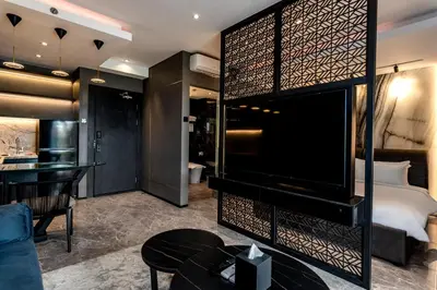 a hotel room with a large bed and a desk at The Umalas Signature in Canggu