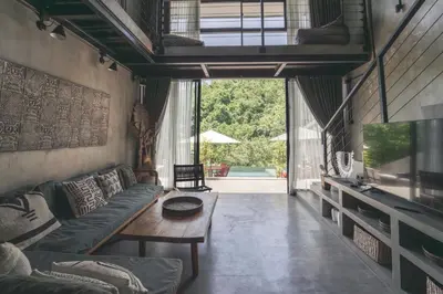 a living room with a couch and a table at The Valley Loft in Ngurah Rai International Airport