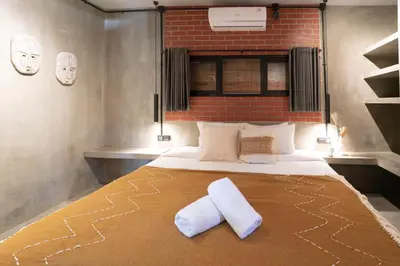 a bedroom with a bed with two pillows on it at The Valley Loft in Ngurah Rai International Airport