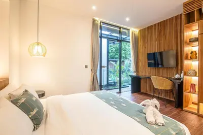 a bedroom with a bed and a tv and a desk at Exquisite 6-Bedroom Retreat, Jacuzzi, AC in Canggu