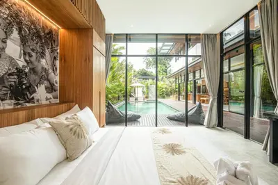 a bedroom with a large bed and a pool at Exquisite 6-Bedroom Retreat, Jacuzzi, AC in Canggu